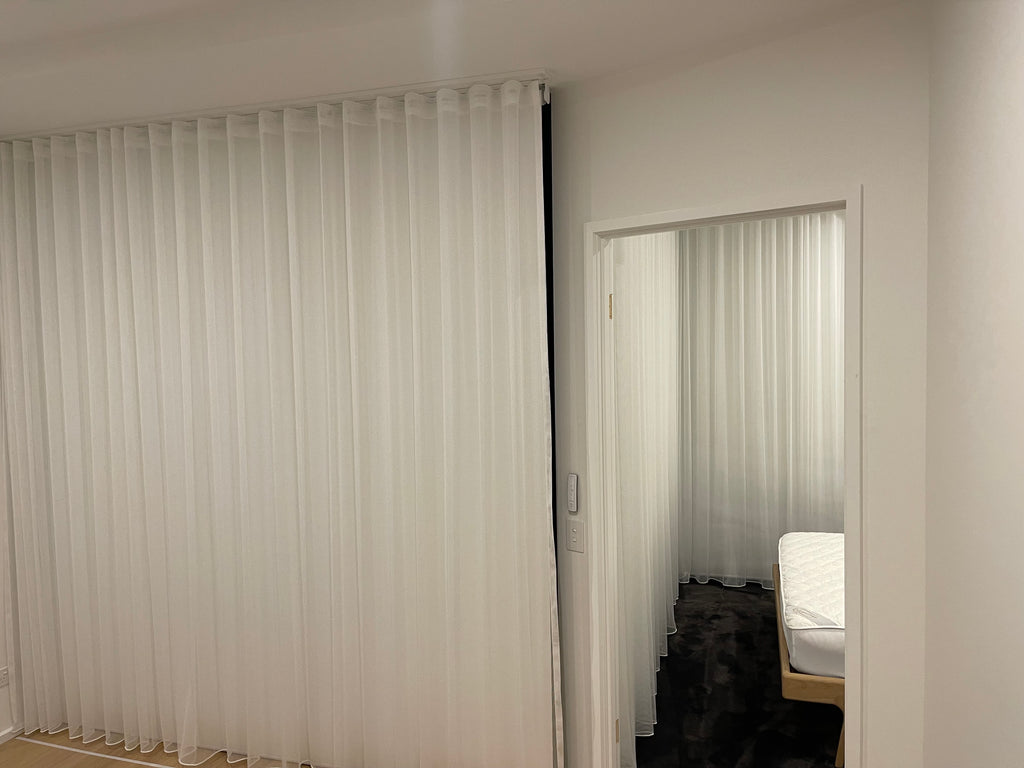 S-curve sheers and battery operated roller blinds behind
